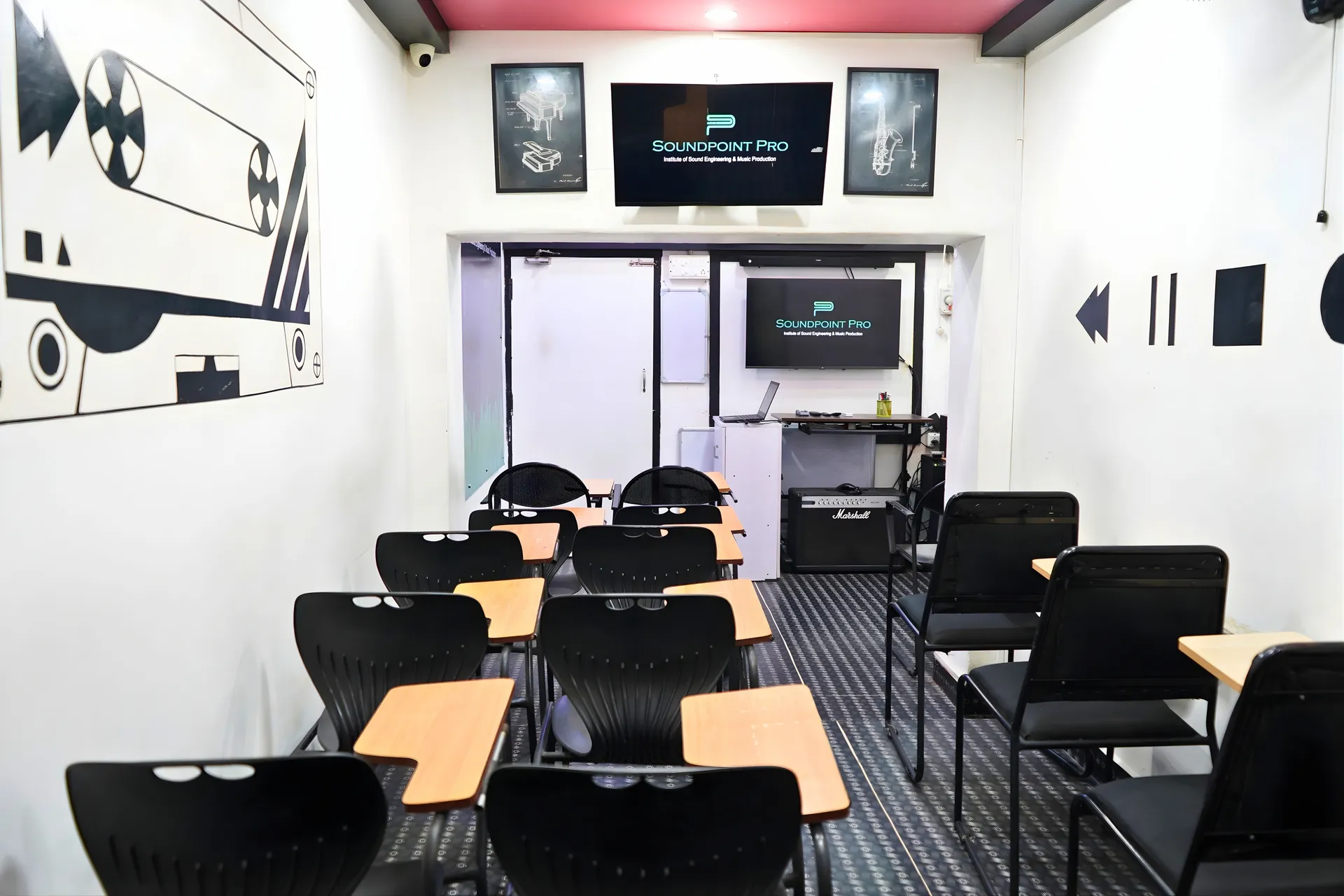 Spacious classroom with projector and seating at Soundpoint Pro